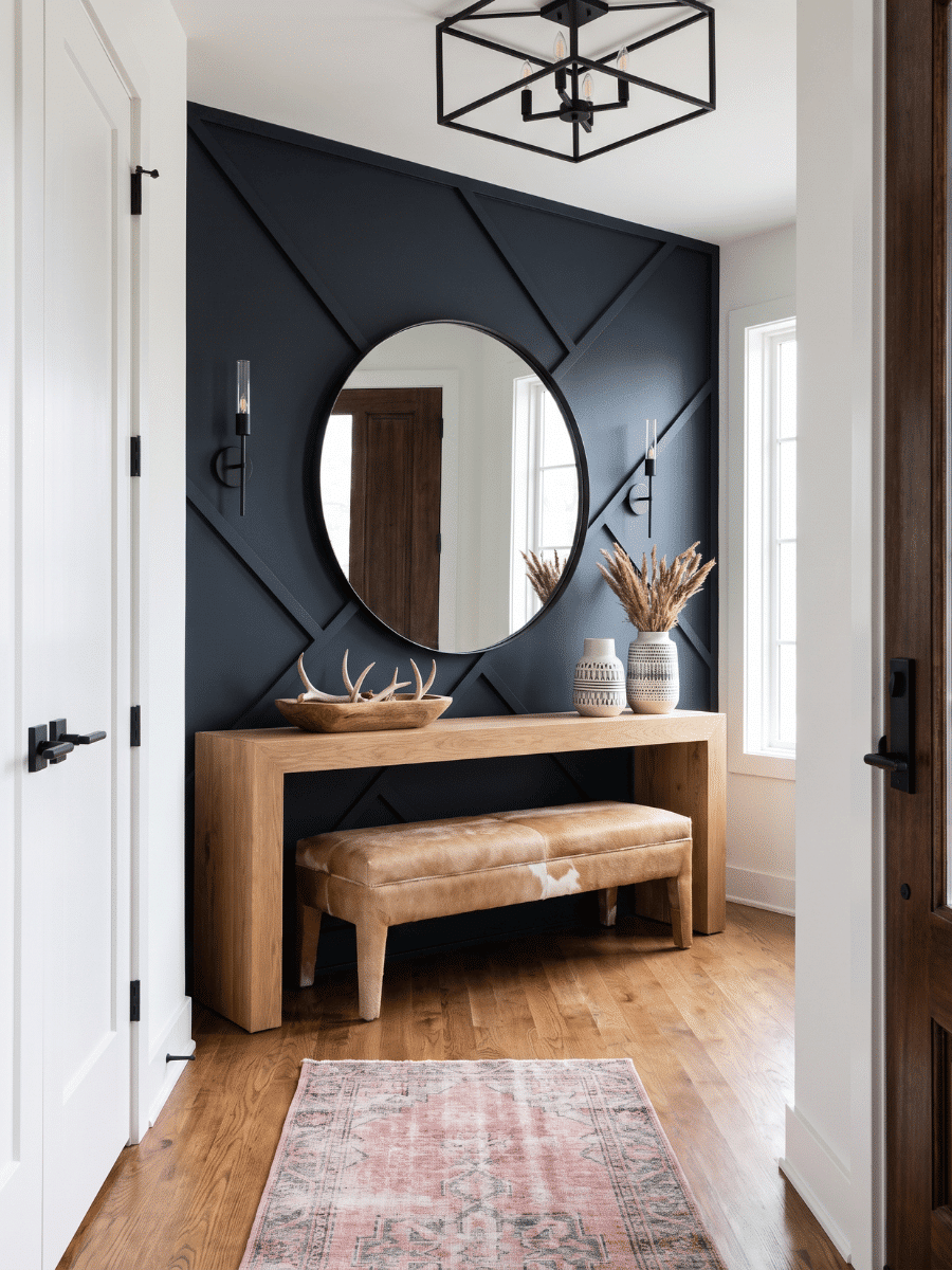 Modern entryway with a round wall mirror, demonstrating a small room looking bigger.