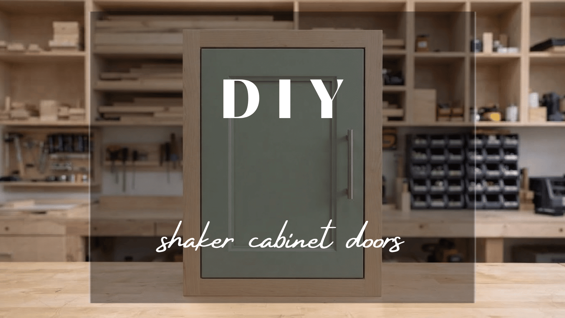 Finished Shaker cabinet door on a workshop bench with recessed panel and green painted finish detail