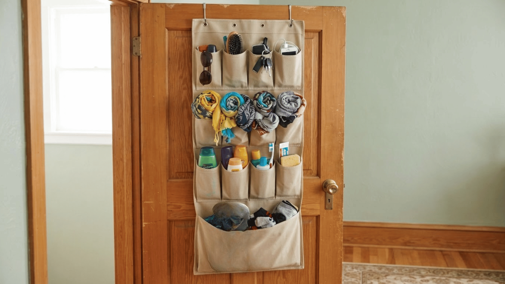 An over-the-door hanging organizer adds pockets for shoes, toiletries, and accessories without using floor or wall space.
